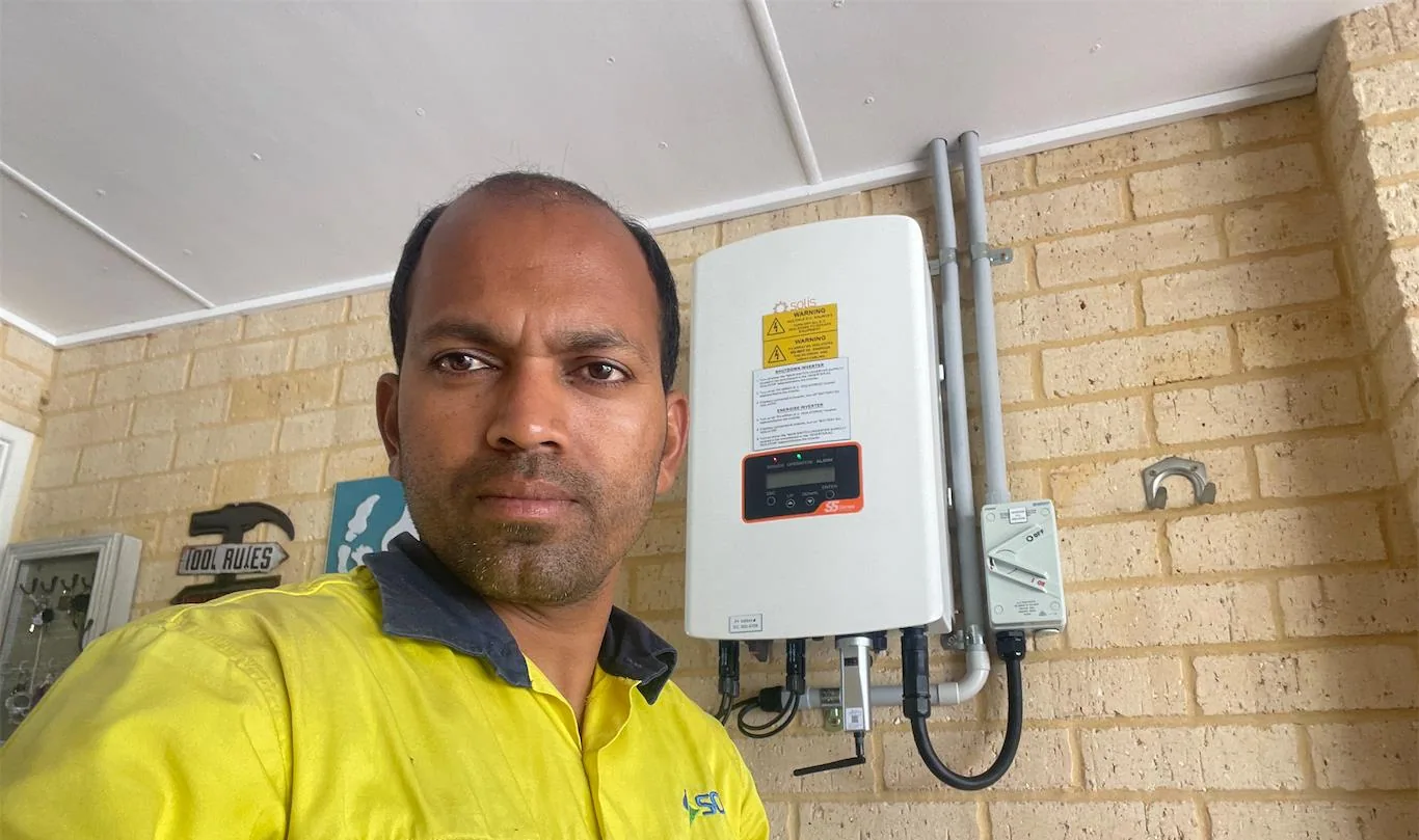 Solar installation worker on site beside residential solar panels, project photo 05