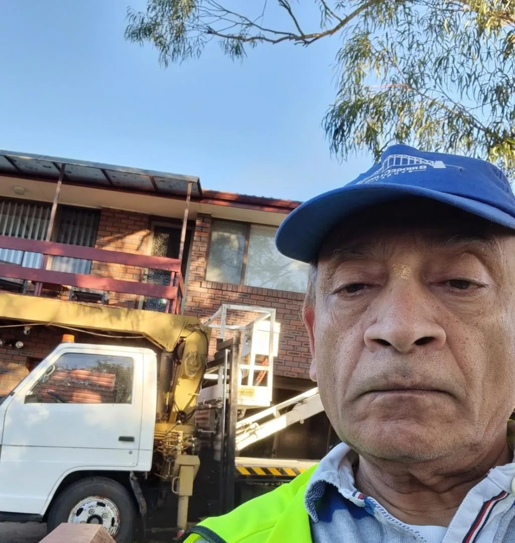 Solar installation worker on site beside residential solar panels, project photo 11