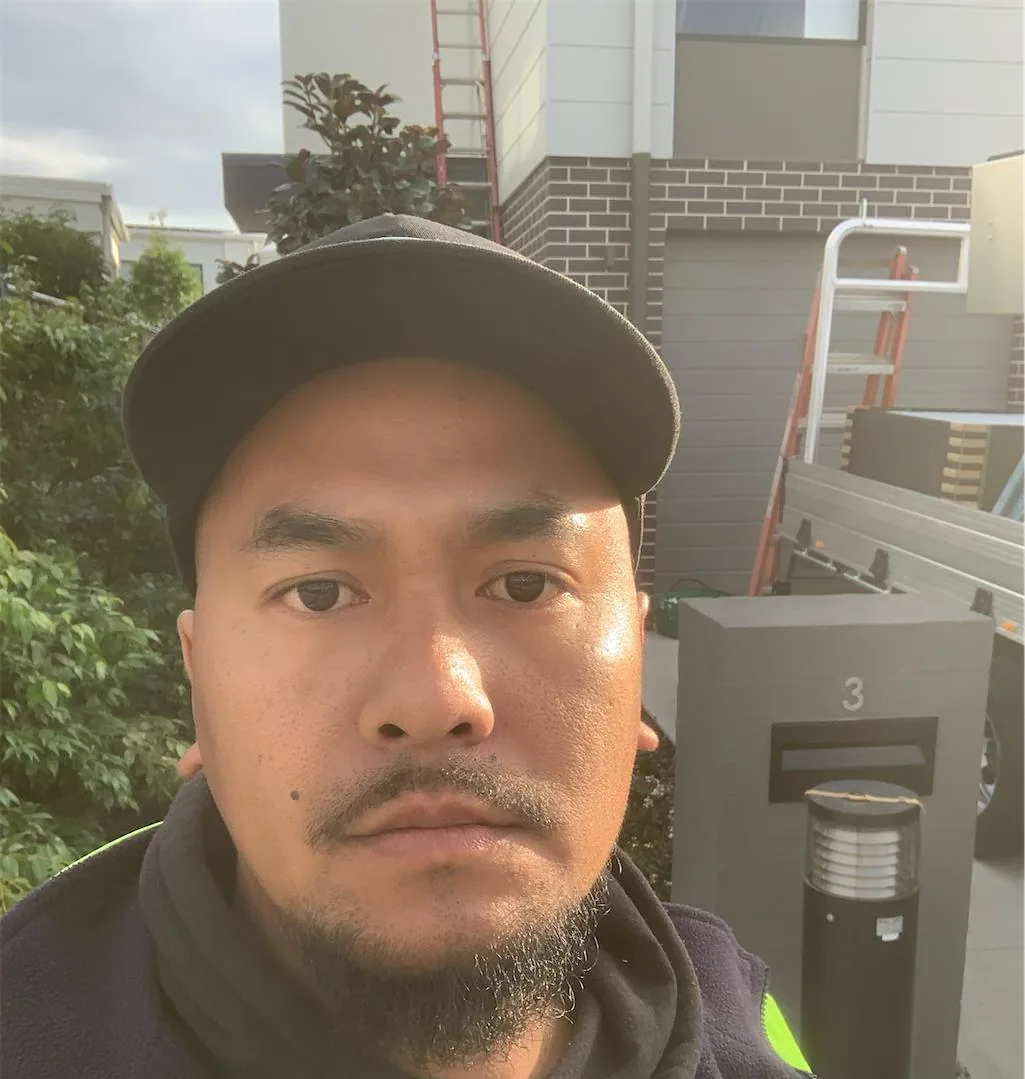 Solar installation worker on site beside residential solar panels, project photo 12