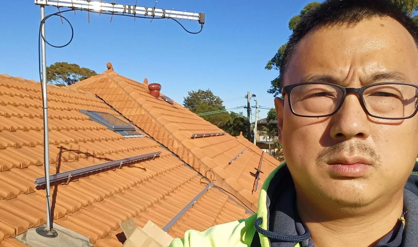 Solar installation worker on site beside residential solar panels, project photo 20