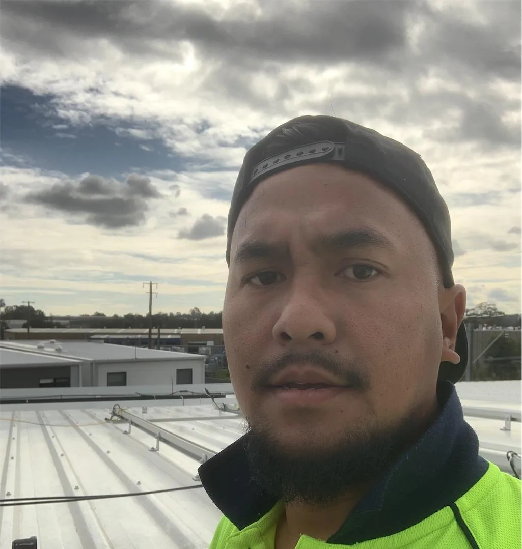 Solar installation worker on site beside residential solar panels, project photo 27