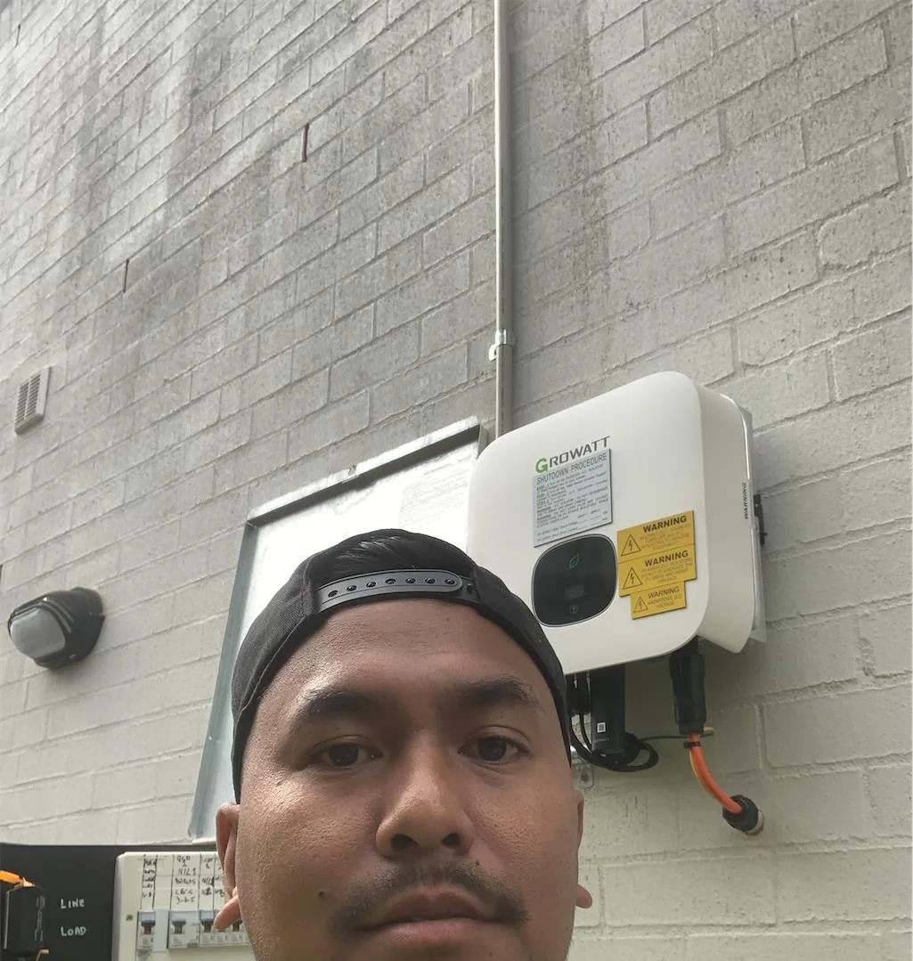 Solar installation worker on site beside residential solar panels, project photo 36