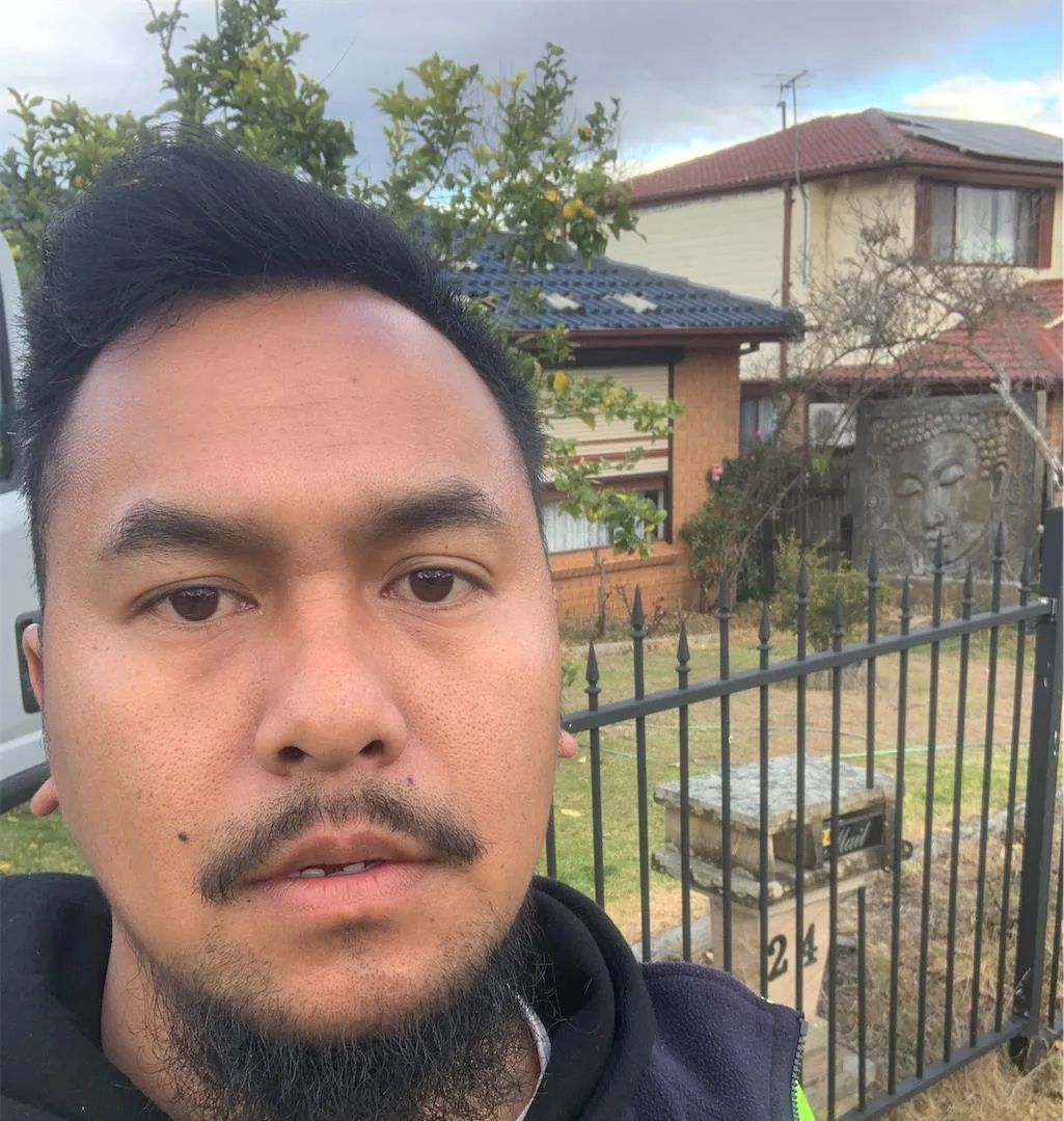 Solar installation worker on site beside residential solar panels, project photo 37