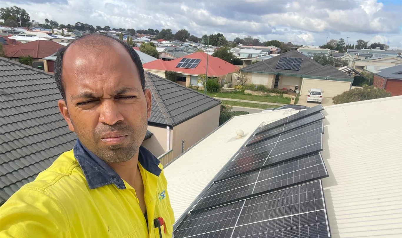 Solar installation worker on site beside residential solar panels, project photo 38