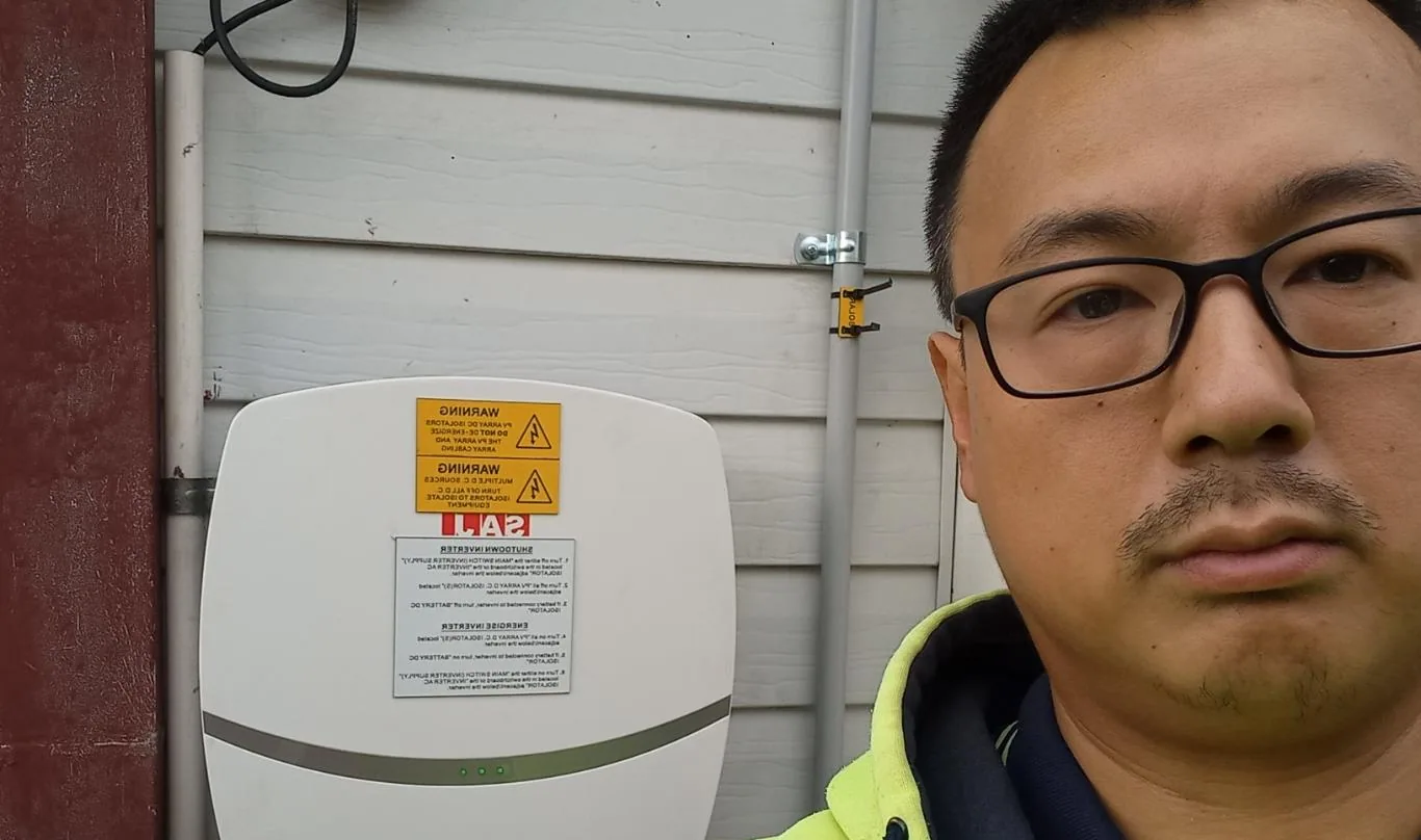 Solar installation worker on site beside residential solar panels, project photo 49