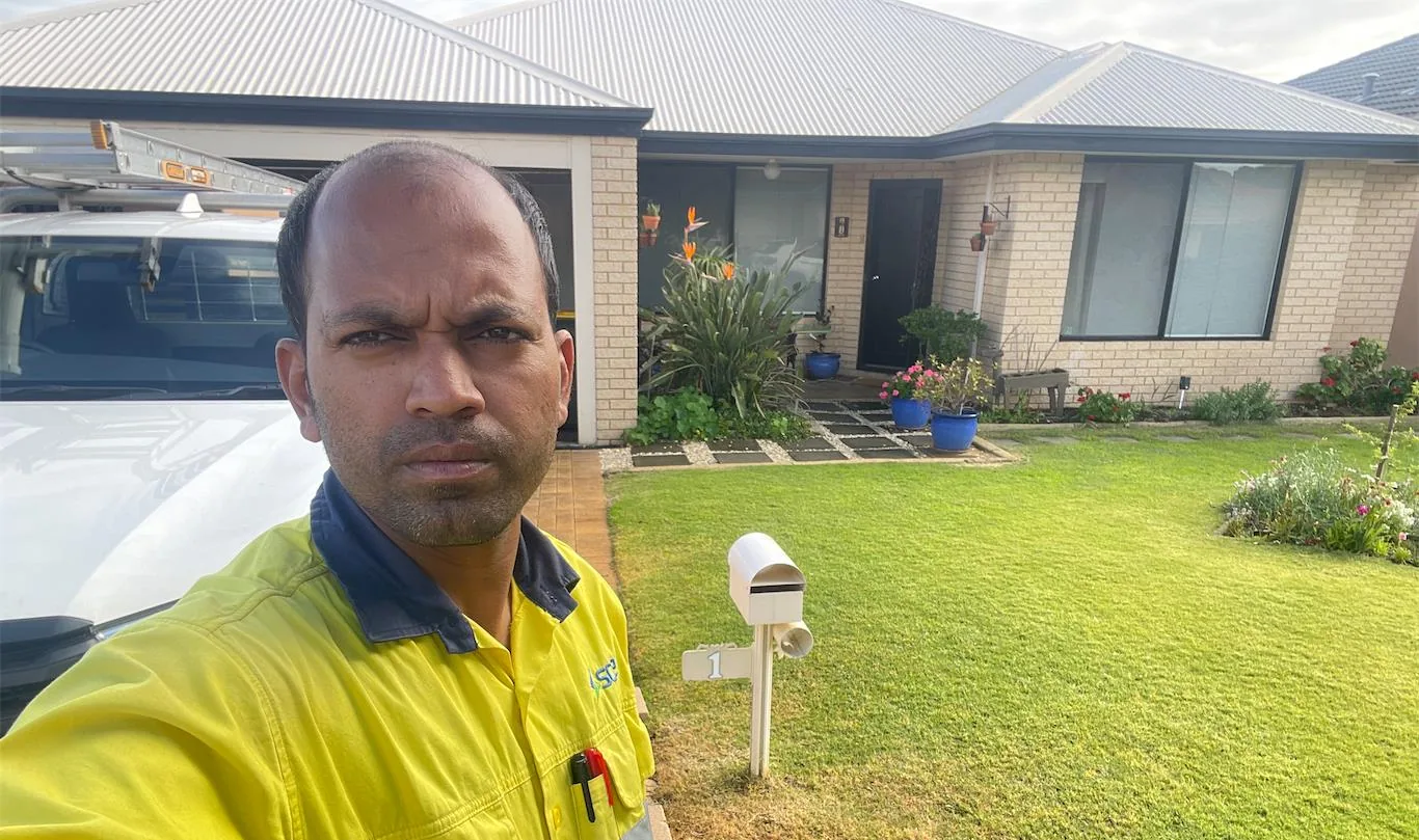 Solar installation worker on site beside residential solar panels, project photo 57