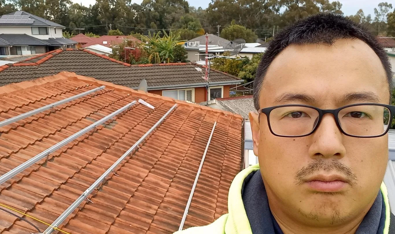Solar installation worker on site beside residential solar panels, project photo 58
